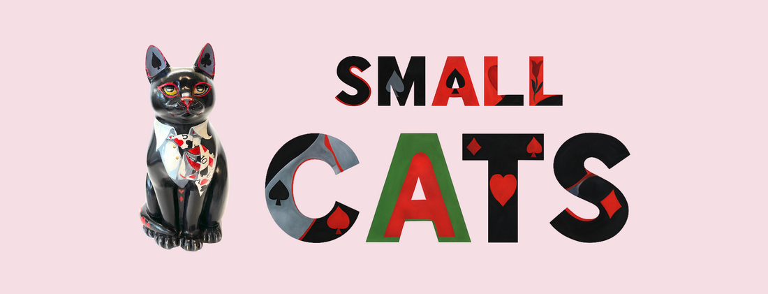 Hand-painted black resin cat sculpture with playing card designs, shown beside stylized text reading “Small Cats” on a soft pink background.