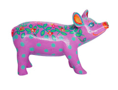 Hand-painted pink miniature pig figurine with green polka dots, leafy vine detailing, and orange floral accents—resin collectible from the Painted Pigs series.