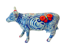 Hand-painted resin mini cow figurine with intricate blue swirls and motifs, featuring a bright orange butterfly on its back, designed by The Painted Pigs