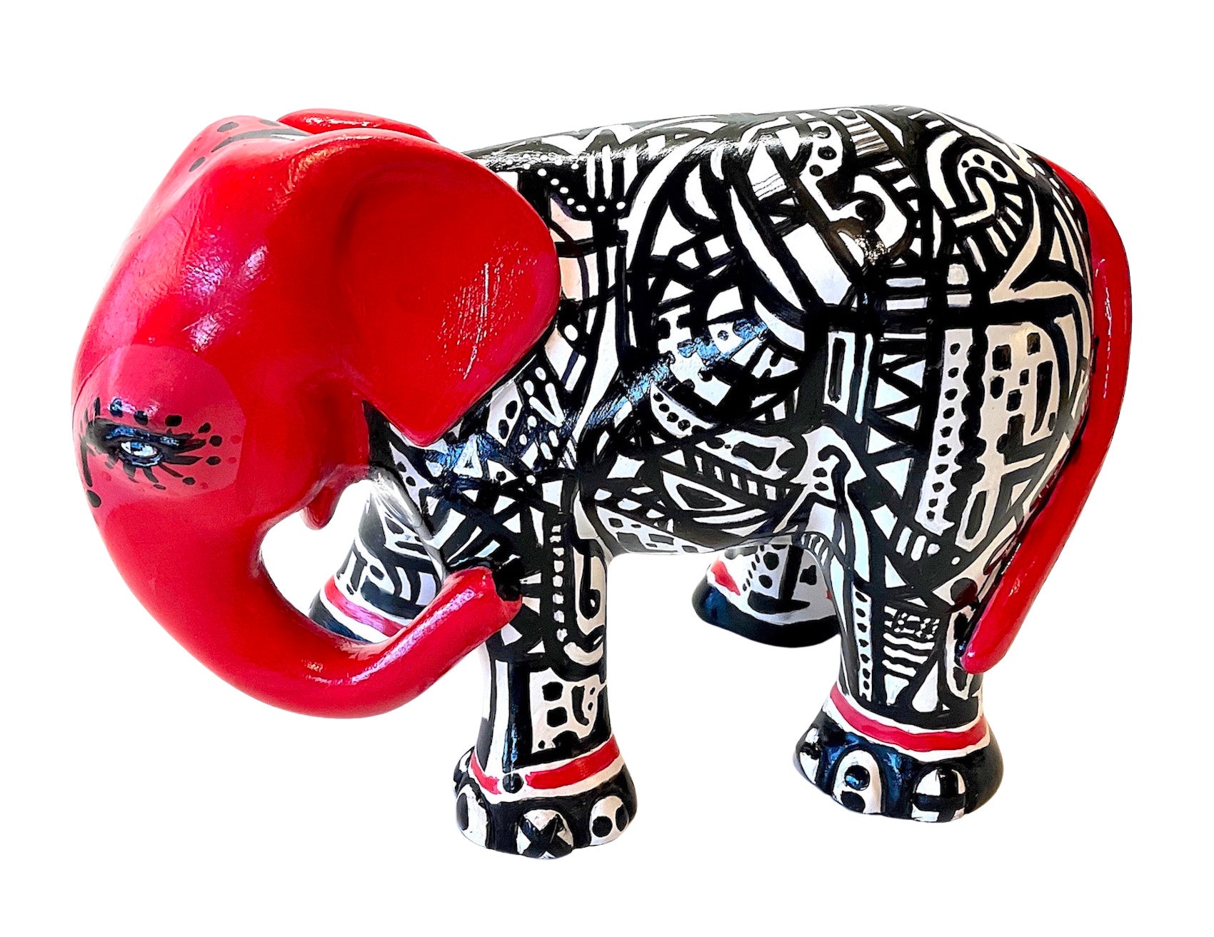Hand-painted resin elephant figurine with red head and tail, and bold black-and-white tribal patterns; a striking, collectible piece of modern décor.
