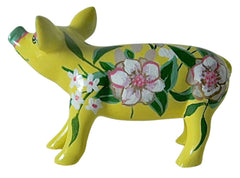Hand-painted yellow miniature pig figurine with white and pink floral designs and green leafy accents—resin collectible from the Painted Pigs collection.
