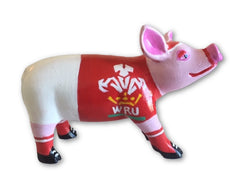 Hand-painted resin pig figurine featuring a red Welsh Rugby Union (WRU) jersey, black rugby boots, and pink accents, from the Painted Pigs collection.