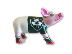 Hand-painted resin pig figurine wearing a green Irish Rugby jersey with a white shamrock emblem, pink accents, and red rugby boots from the Painted Pigs collection.