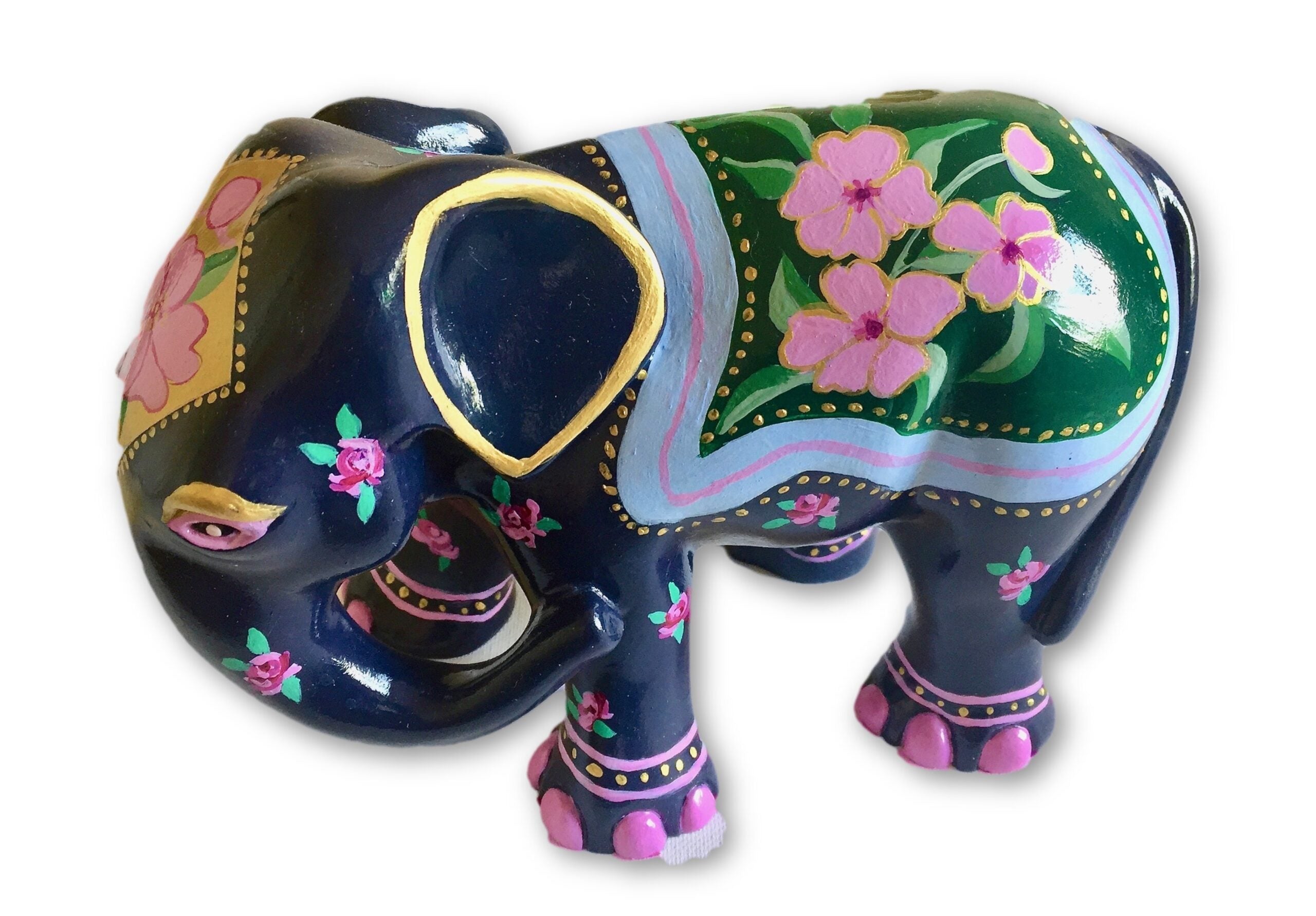 Hand-painted navy-blue resin elephant figurine with pink floral patterns, green and gold saddle detailing, and decorative accents from the Painted Pigs collection.